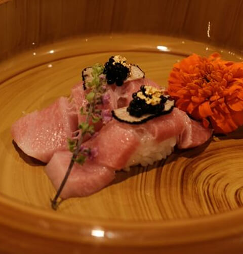 A blue plate of vibrant sushi pieces-1